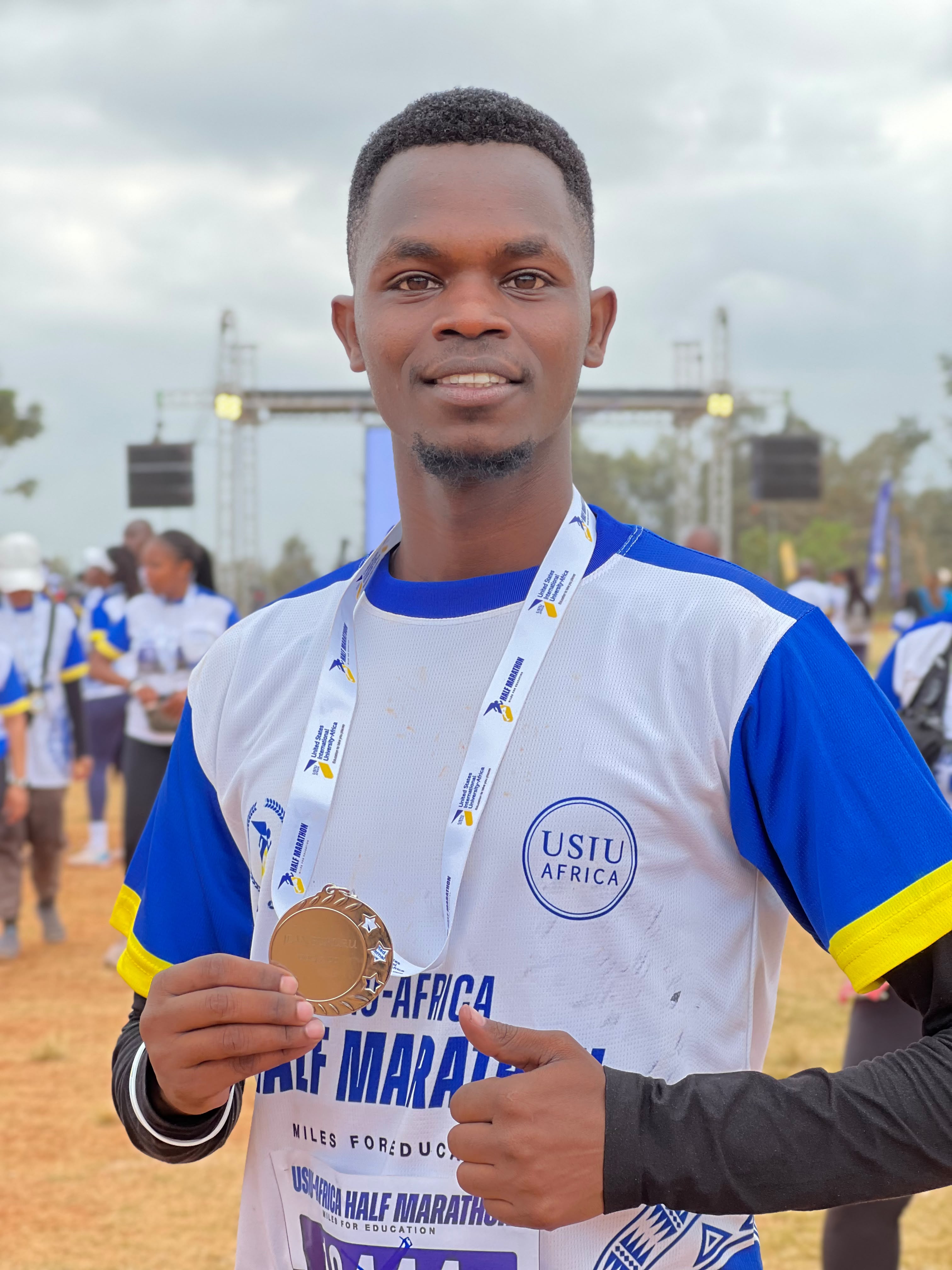 Jean Bukuru with his medal after completing the 10 KM Miles for Education run at the USIU-Africa Half Marathon